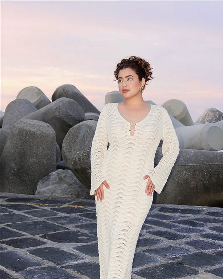 Shirly Luxe Crochet Knit Dress -Resortwear In Beige - front shot on model on stone embankment - Miss Mosa By Akanksha