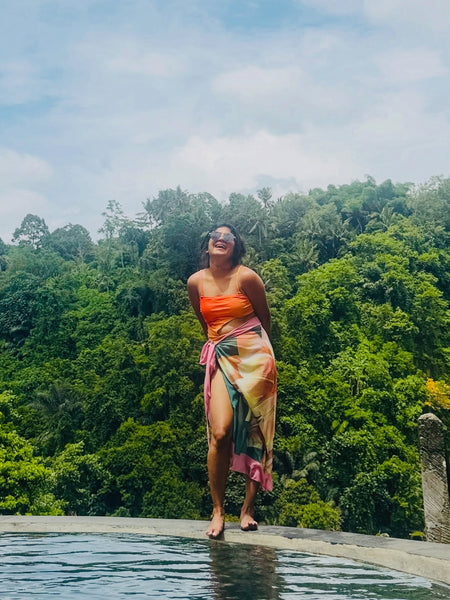 Sunset Swimsuit With Sarong In Orange - full-length shot on model at pool edge - Miss Mosa By Akanksha