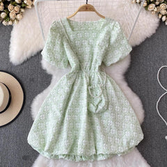 Susaine floral statement dress with bag - styled flat-lay shot, green - Miss Mosa By Akanksha
