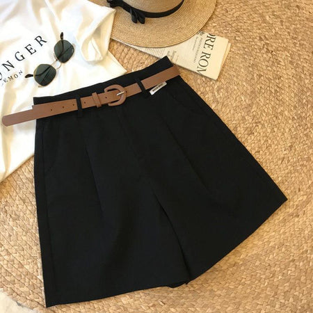 Sutton Statement Shorts With Belt In Black - flat-lay product shot with belt and sun hat - Miss Mosa By Akanksha
