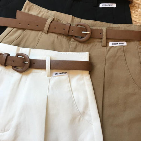 Sutton Statement Shorts With Belt In White - flat-lay product shot of stacked shorts with belts - Miss Mosa By Akanksha