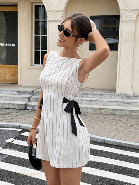Tamar Bow Mini Dress - three-quarter shot, cream with grey pinstripes and black bow - Miss Mosa By Akanksha