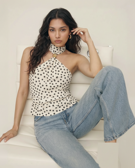 Taurel Halterneck Polka Top - seated full-length shot, cream with black polka dots - Miss Mosa By Akanksha