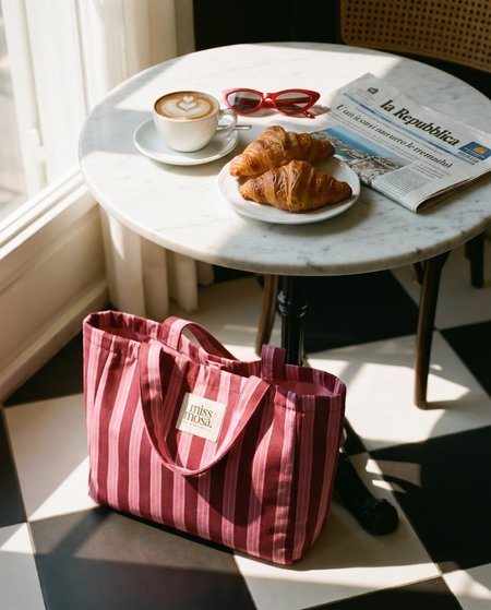 The Miss Mosa Tote Bag - Pink Striped - styled lifestyle shot with cafe table, pink and maroon striped - Miss Mosa By Akanksha