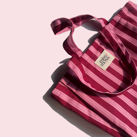 The Miss Mosa Tote Bag - Pink Striped - close-up of handle and brand label, pink and maroon striped - Miss Mosa By Akanksha