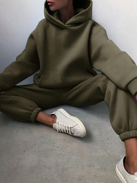 Varya Statement Tracksuit - seated shot on model, olive green - Miss Mosa By Akanksha
