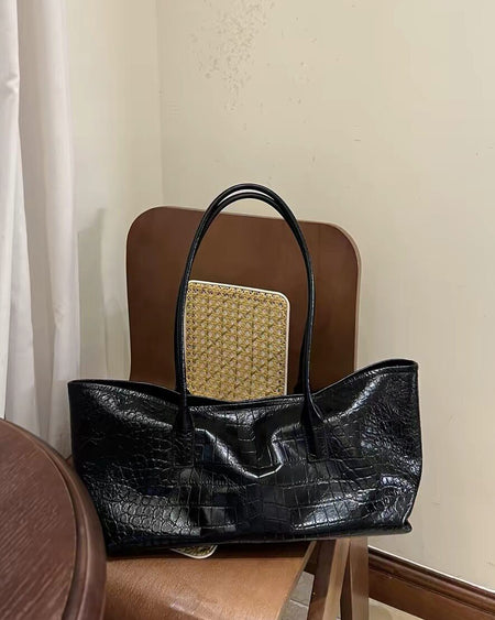 Xavi Textured PU Tote Bag With Pouch - styled product shot with pouch on a chair, black - Miss Mosa By Akanksha
