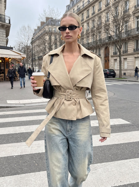 Beige short double breasted trench coat with belt, worn open with baggy vintage jeans