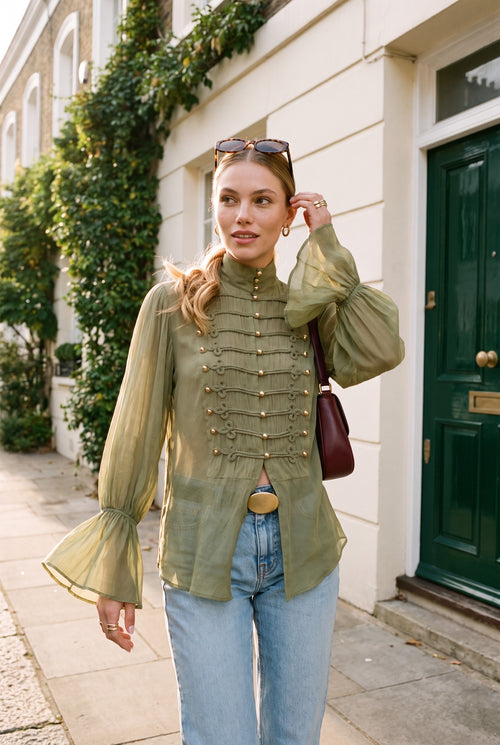 Olive military style buttoned top with gold buttons, braid detail and bell sleeves, styled with light blue jeans